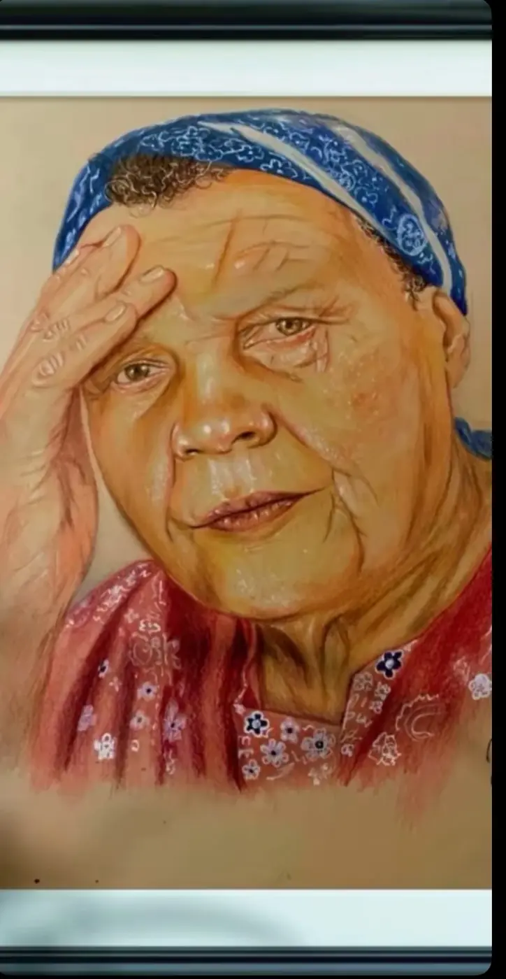 Framed portrait of a person in a blue patterned headscarf, resting a hand against the forehead.